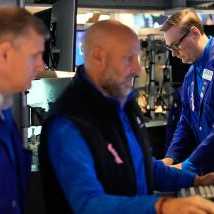 Patrick King, right, and others work on the floor at the New York Stock Exchange in New York, Wednesday, Oct. 1, 2025. (AP Photo/Seth Wenig)