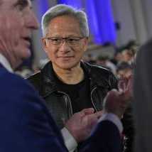 Nvidia CEO Jensen Huang talks with Interior Secretary Doug Burgum, left, before President Donald Trump speaks during an AI summit at the Andrew W. Mellon Auditorium, Wednesday, July 23, 2025, in Washington.