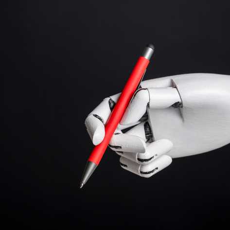 A robotic hand holding a red pen on a black background, blending modern technology with timeless utility
